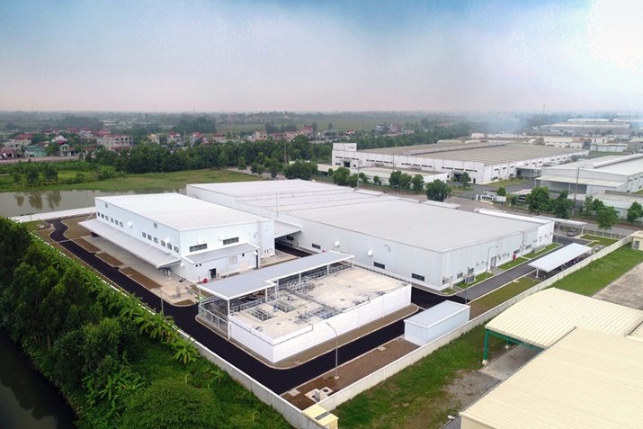 Factory workers inspecting metal components