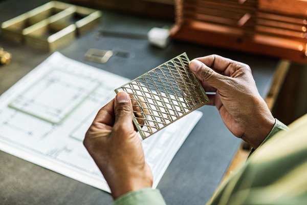 Skilled engineer holding thin metal sheet (ID#2)