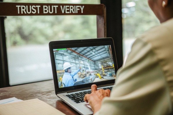 Factory worker watching welding video on laptop (ID#4)