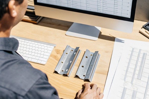 Customs broker analyzing harmonized schedule codes on a computer (ID#5)