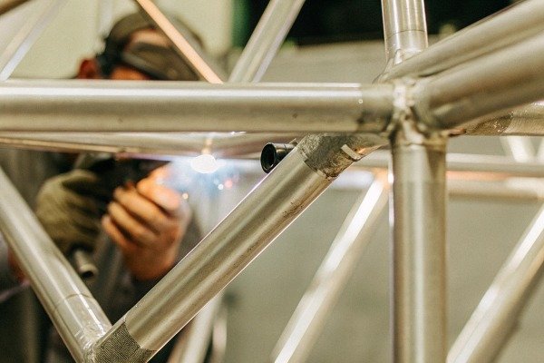 Welder working on metal frame structure (ID#4)