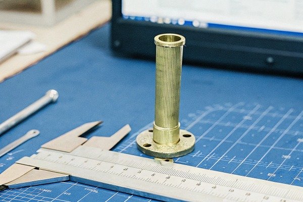 Metal part and caliper on blueprint (ID#4)