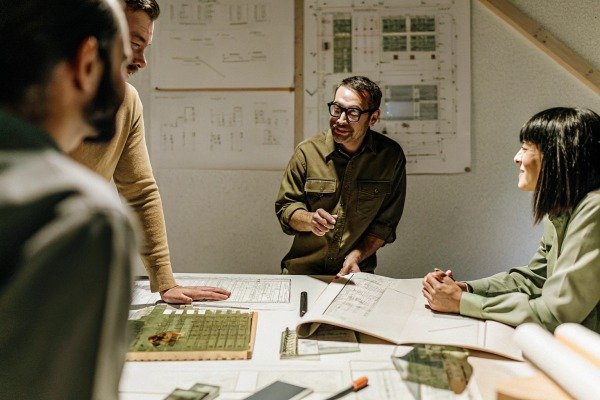 Team discussing architectural plans (ID#5)