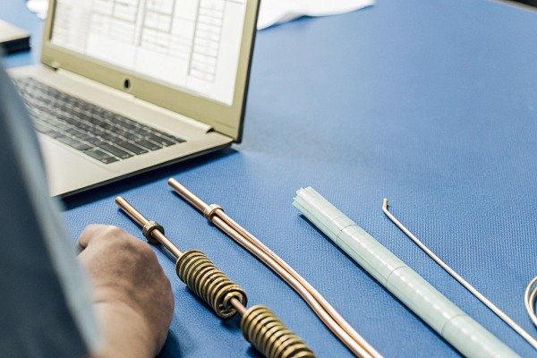 Metal parts and laptop on blue table (ID#2)