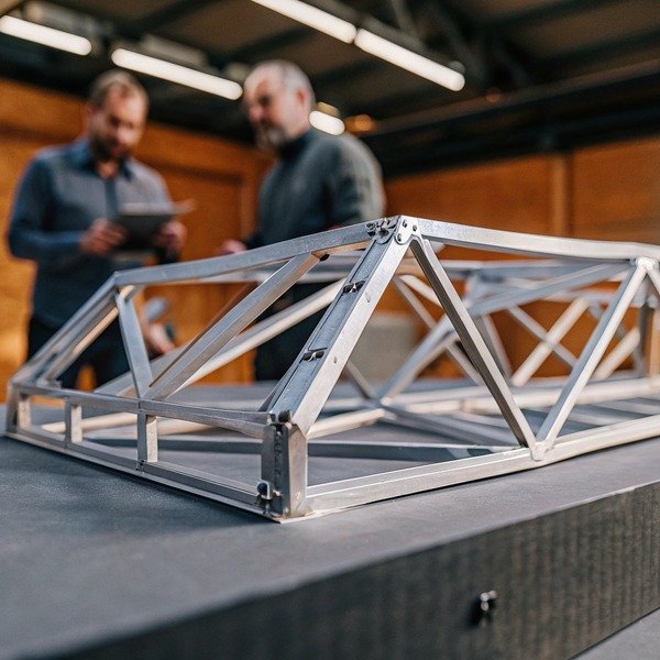 Metal framework structure on table in workshop (ID#1)