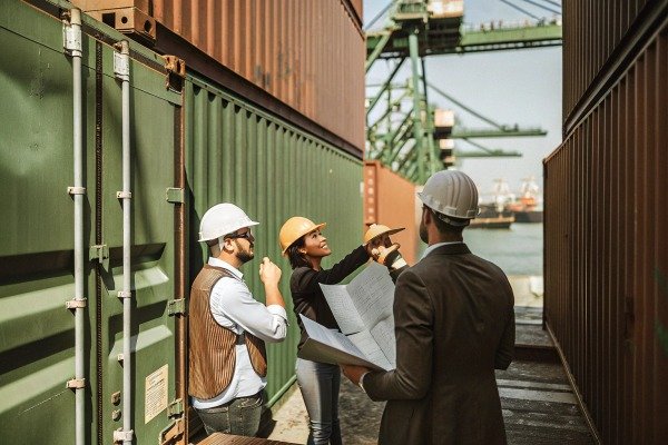 Team inspecting shipping containers at port (ID#5)