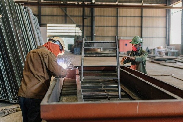 Workers welding metal in factory (ID#3)