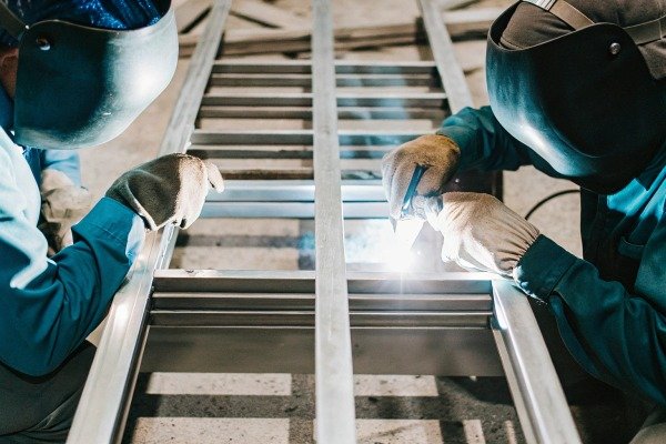 Workers welding metal frame structure (ID#3)