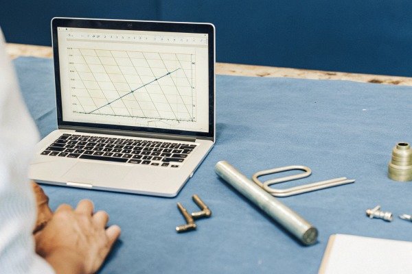 Laptop showing engineering graph with tools (ID#2)