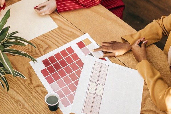 Designers reviewing color swatches and layouts (ID#4)