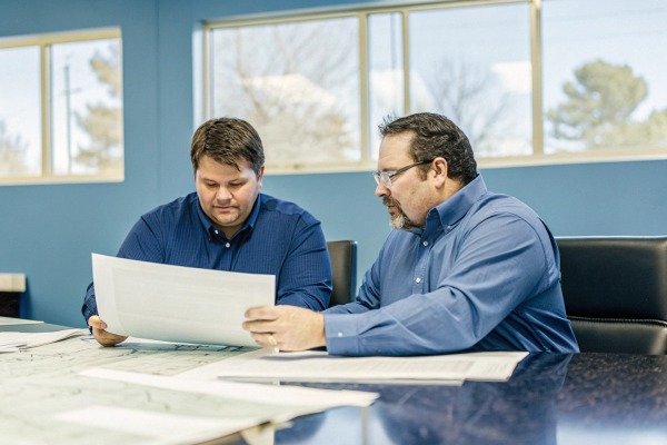 Two men discussing plans in office (ID#5)