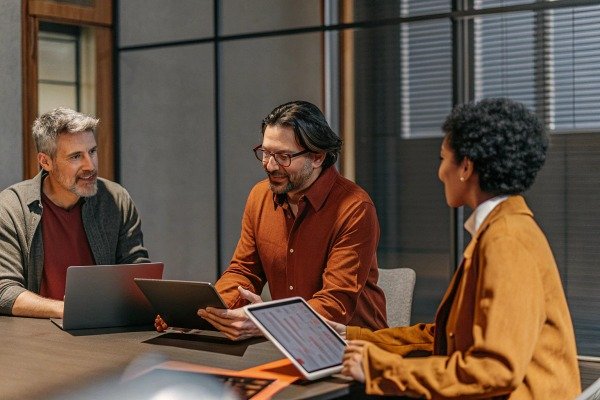 Team meeting with laptops and tablet in office (ID#4)