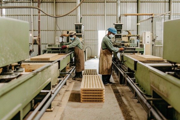 Workers operating machinery in factory (ID#3)