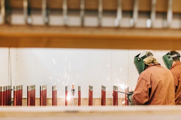 Workers welding metal pipes with sparks flying (ID#2)
