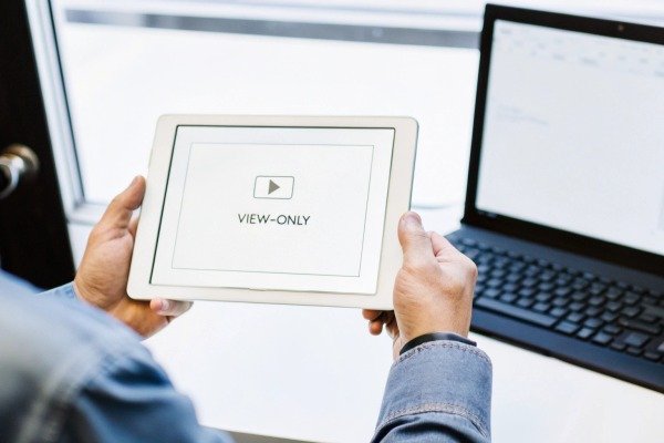 Person holding tablet showing view-only screen (ID#3)