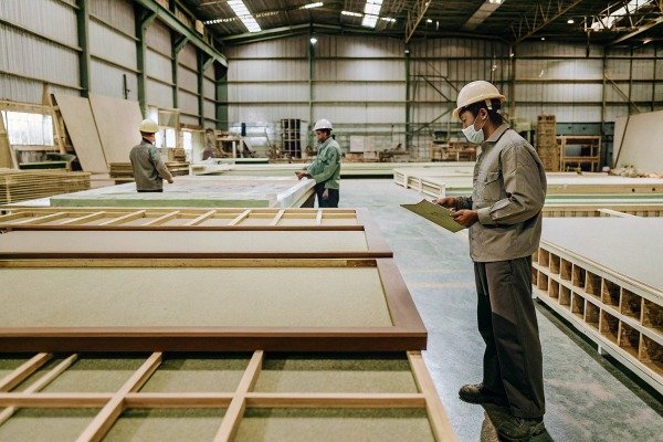 Workers inspecting materials in large warehouse (ID#5)
