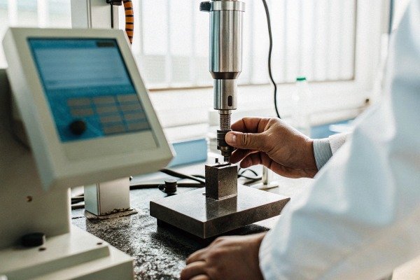 Technician operating precision machine tool (ID#2)