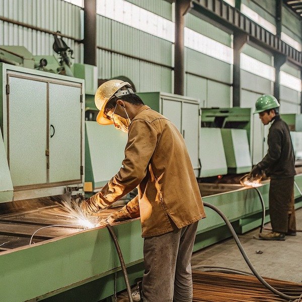 Worker welding metal in factory workshop (ID#1)