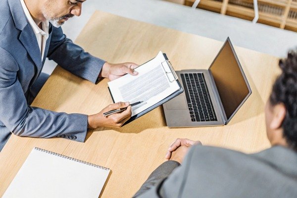 Business meeting with document and laptop (ID#5)