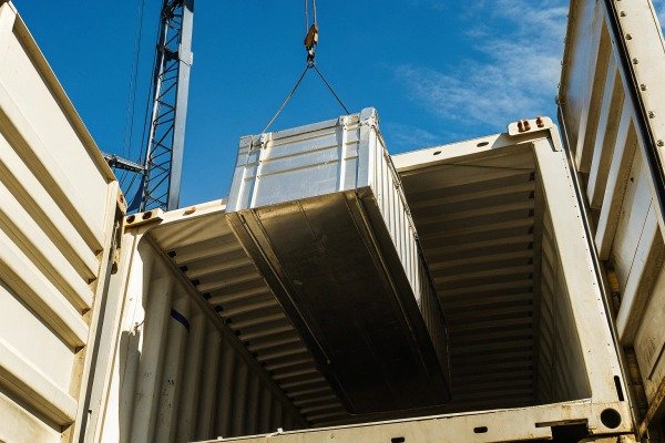 Crane loading container into shipping container (ID#4)