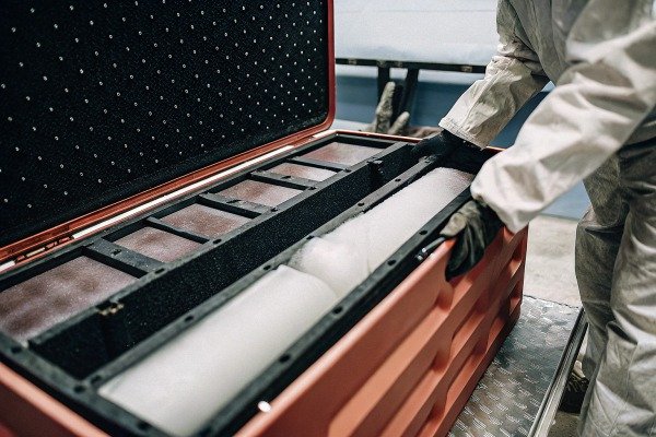 Person opening protective case with foam padding (ID#4)