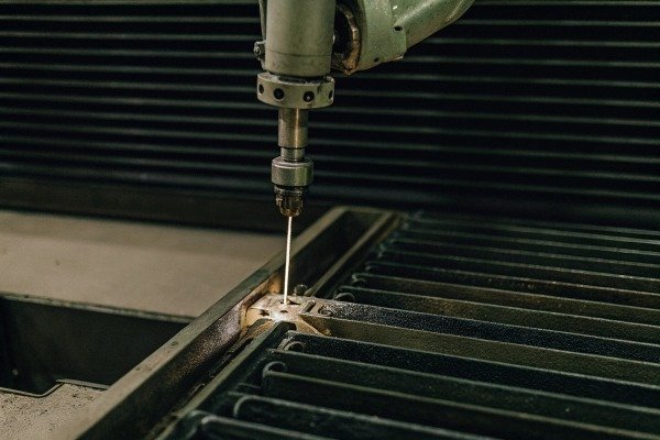 Close-up of industrial drill machine in action (ID#3)