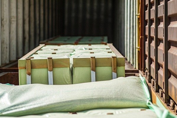 Stacked green bags inside shipping container (ID#3)