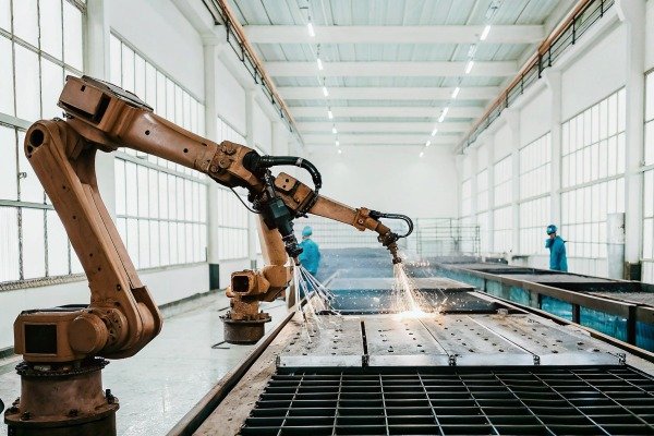 Industrial robotic arm welding metal parts (ID#3)