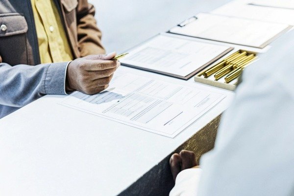 Close-up of hands with documents and pen (ID#2)