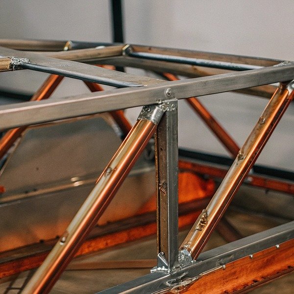 Metal frame construction close-up with copper tubes (ID#1)