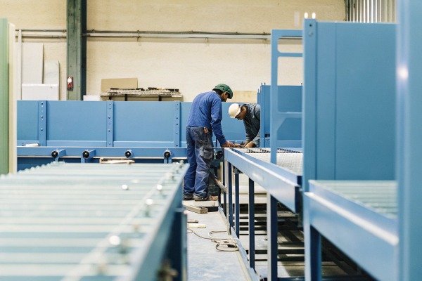 Workers inspecting machinery in factory (ID#4)