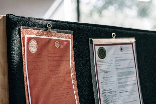 Official certificates pinned on black board (ID#4)