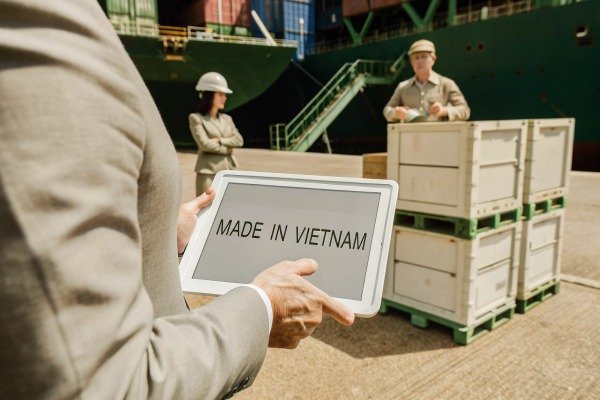 Person holding tablet with 'Made in Vietnam' text (ID#5)