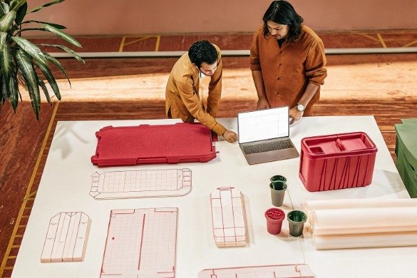 Procurement manager reviewing technical specs and 3D CAD files (ID#1)