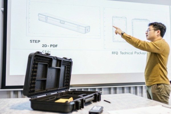 Open conference room reviewing CAD and 2D drawings (ID#2)