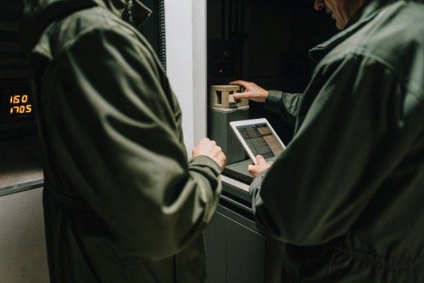 Laboratory technician testing blow-molded parts for quality assurance (ID#5)