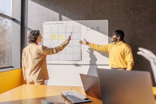 Buyers and suppliers reviewing price adjustment formula in meeting (ID#5)